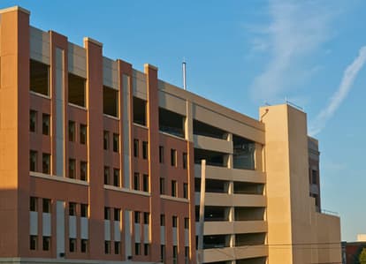 Red brick parking garage with blue sky in the background