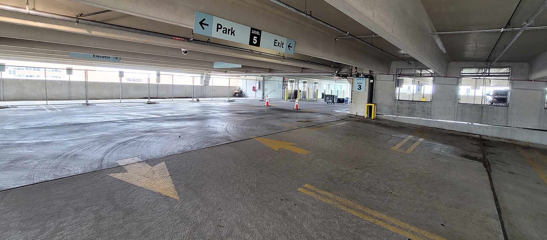 Concrete parking garage interior fenced off for maintenance