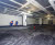 Workers scarifying parking garage concrete