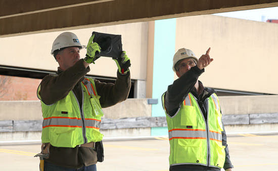 Two engineers reviewing structural health assessment