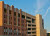 Red brick parking garage with blue sky in the background