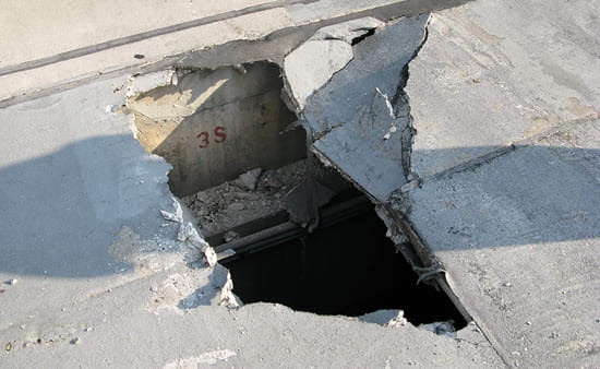 Hole in parking garage concrete